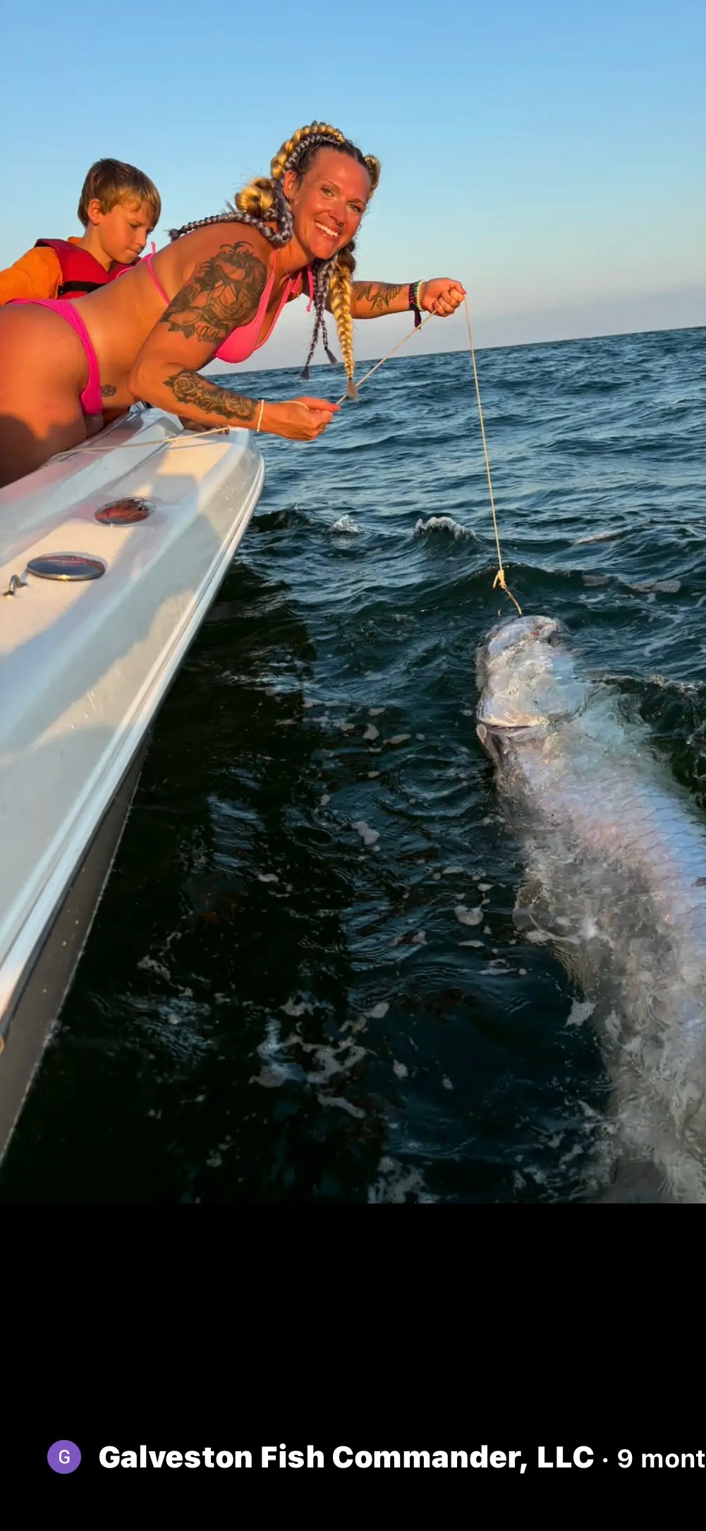 Angler with shark boat-side on Galveston offshore fishing trip